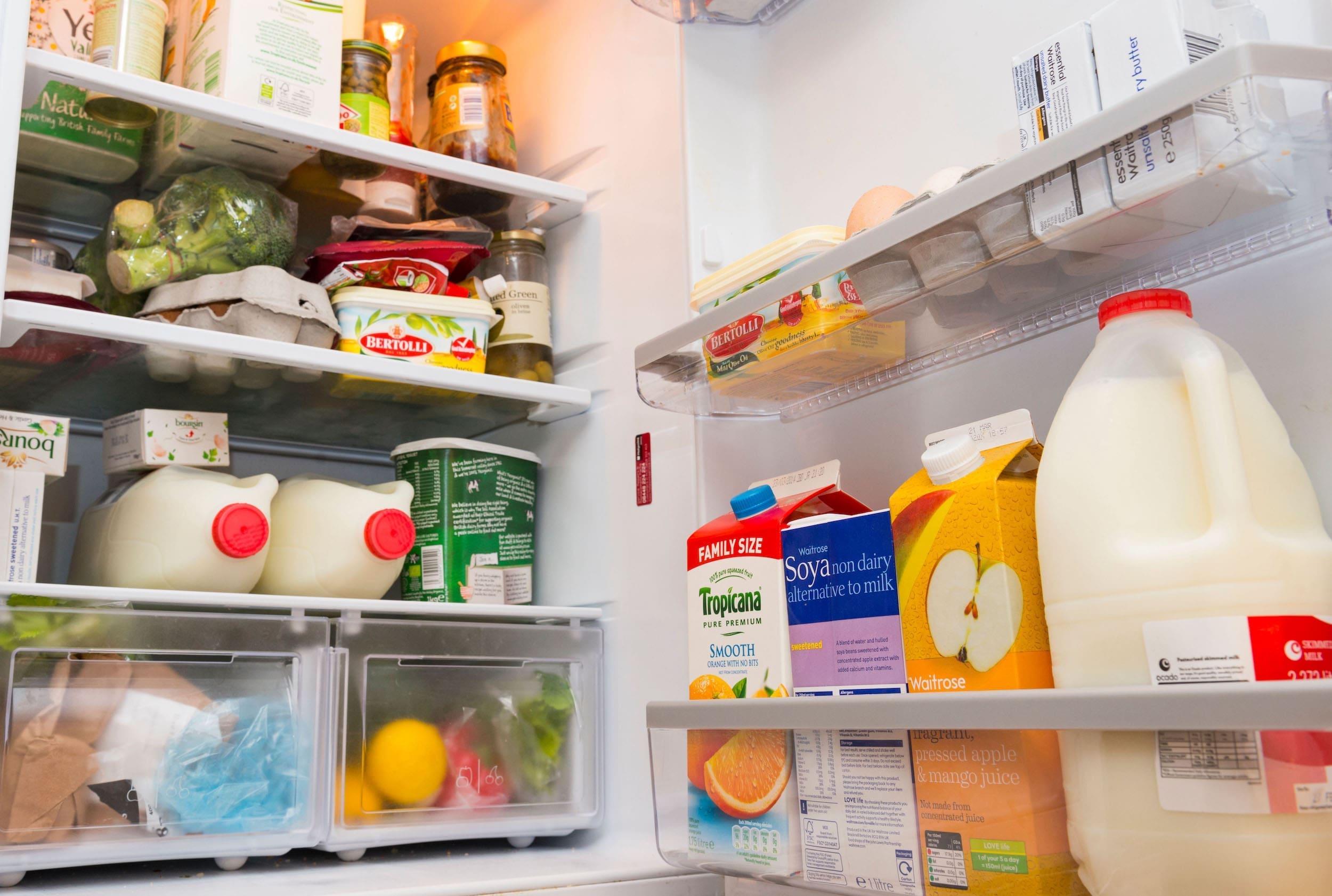 image of an opened fridge stocked with food