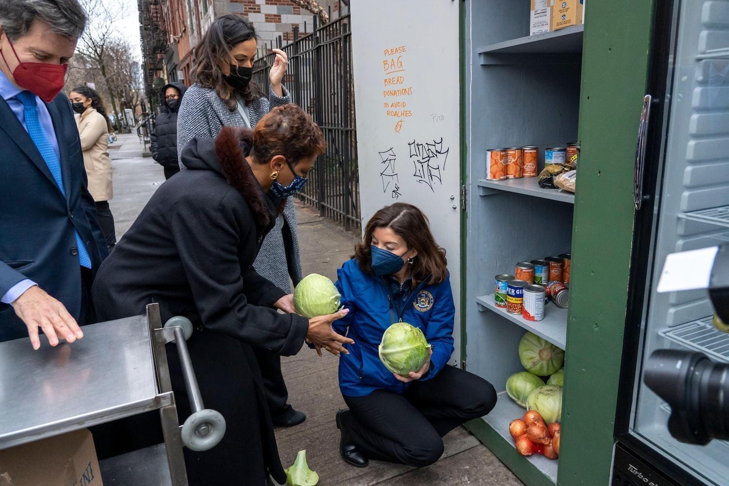 image of volunteers filling a fridge